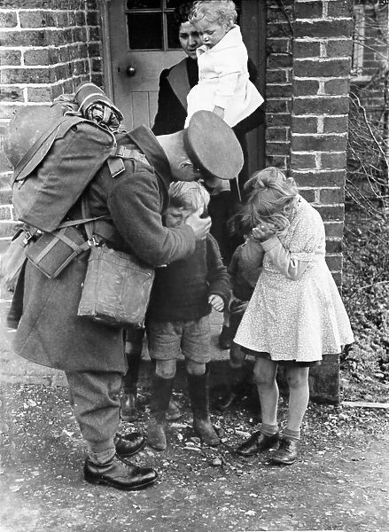 John Maynard, back from leave. Picture shows him re-united with children and a lady