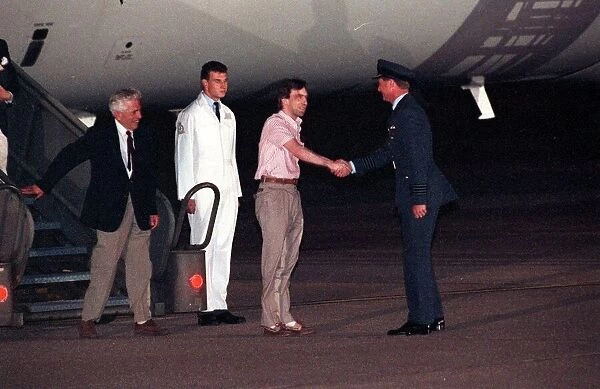 John McCarthy arrives back in Britain at RAF Lyneham, shaking hands with RAF Station