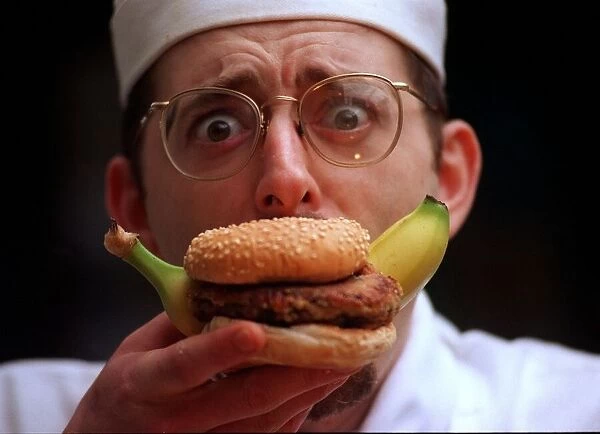 John Quigley chef eating a banana burger
