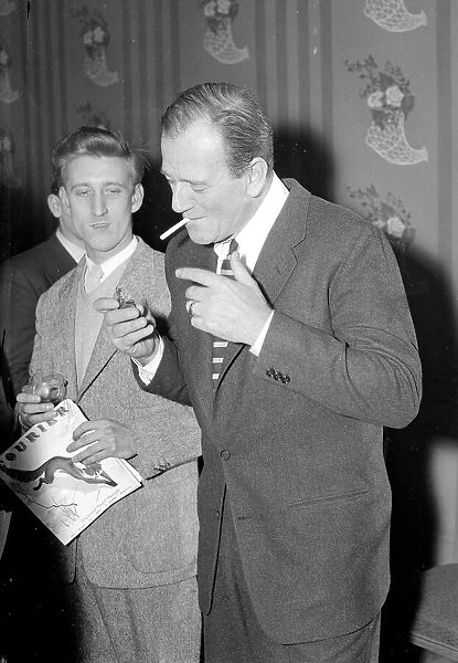 John Wayne in London lighting a cigarette February 1956
