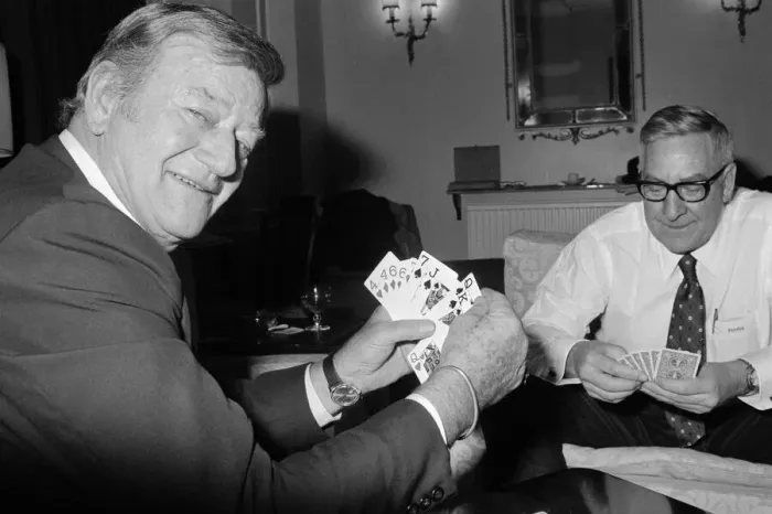 Framed Print : John Wayne pictured relaxing playing cards in his suite at The Connaught Hotel, Mayfair Framed Print : John Wayne pictured relaxing playing cards in his suite at The Connaught Hotel, Mayfair