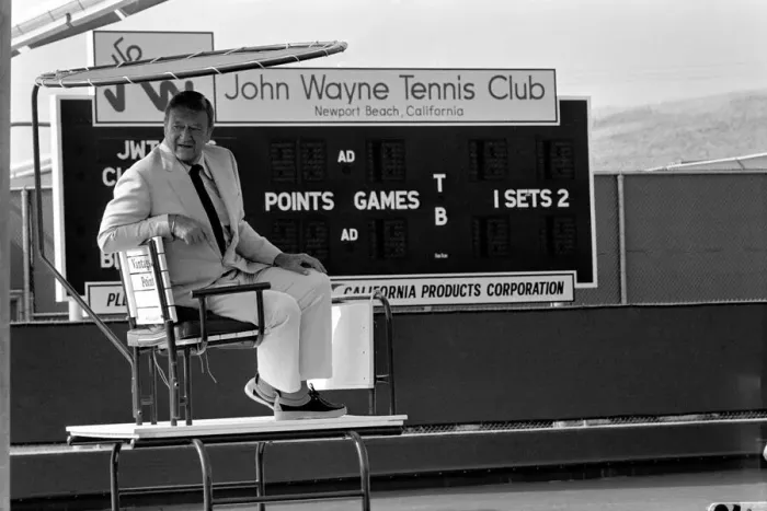 Framed Print : John Wayne who stars in Brannigan. Seen here at his tennis club