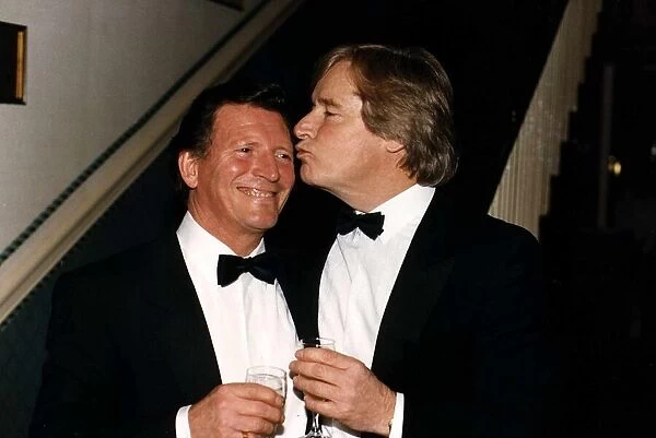 Johnny Briggs Actor gets a kiss from Bil Roache at a party