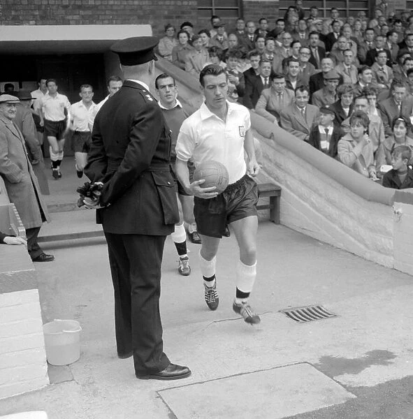 Johnny Haynes of Fulham leading his team out for a league division one match at Craven