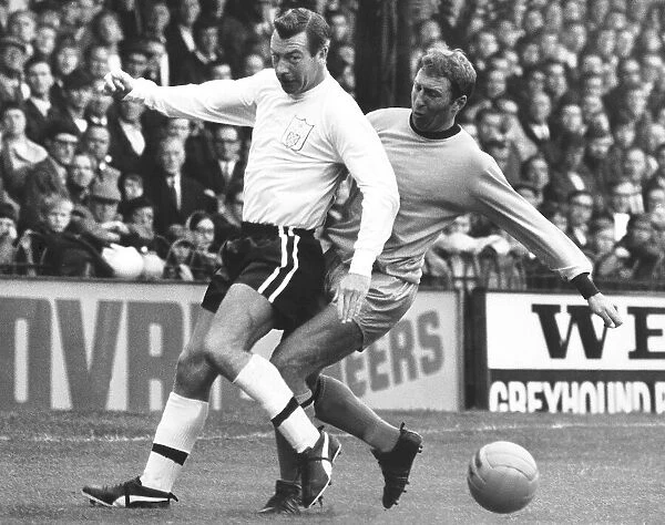 Johnny Haynes of Fulham being tailed by Mike Bailey of Wolves. August 1967