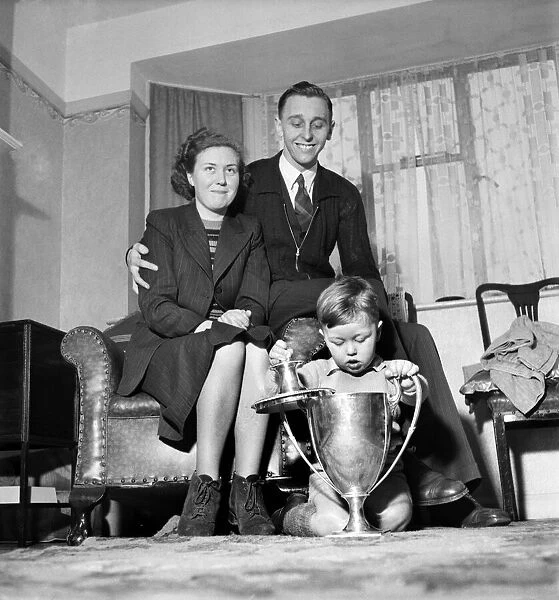 Johnny Leach, new world table tennis champion with wife and son and trophies