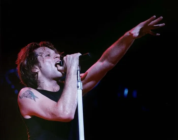 Framed Print : Jon Bon Jovi lead singer of rock group Bon Jovi raises his hand to the audience while