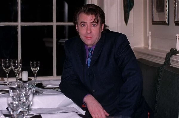Jonathan Ross TV Presenter December 1997 Siting at table A©mirrorpix