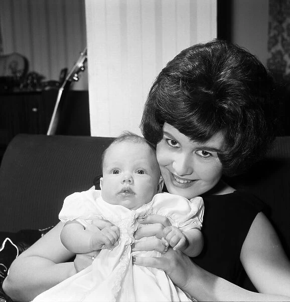 Joyce Wilde at home in Chiswick with her baby daughter Kim. 30th January 1961