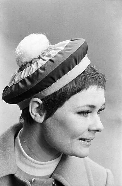 Judi Dench being photographed by the press wearing a Christian Dior beret called '