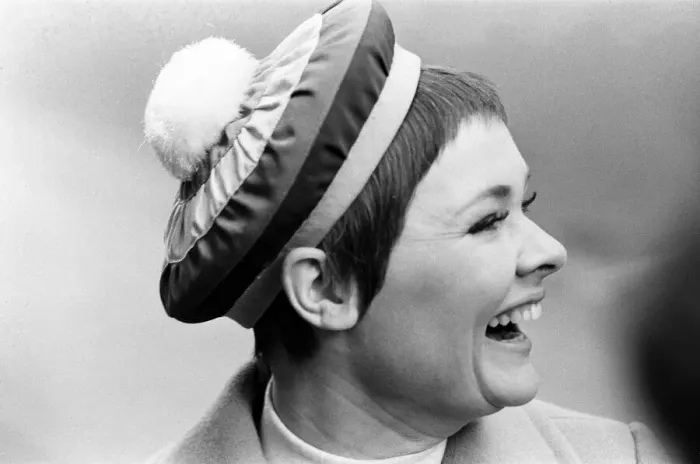 Framed Print : Judi Dench being photographed by the press wearing a Christian Dior beret called Framed Print : Judi Dench being photographed by the press wearing a Christian Dior beret called