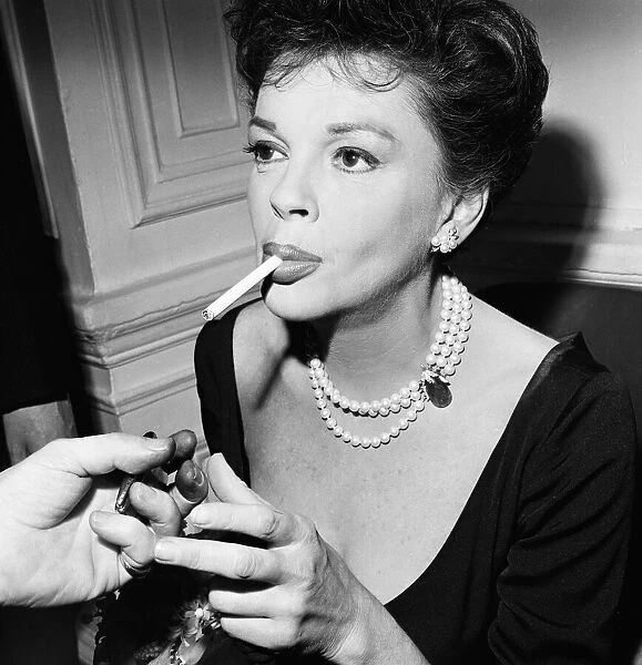 Judy Garland lighting a cigarette. 1963