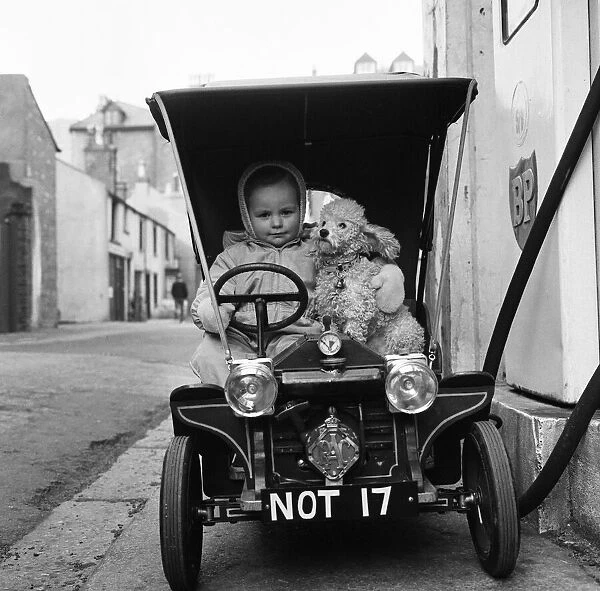 Judy Oliver in her vintage baby car. 1st March 1964