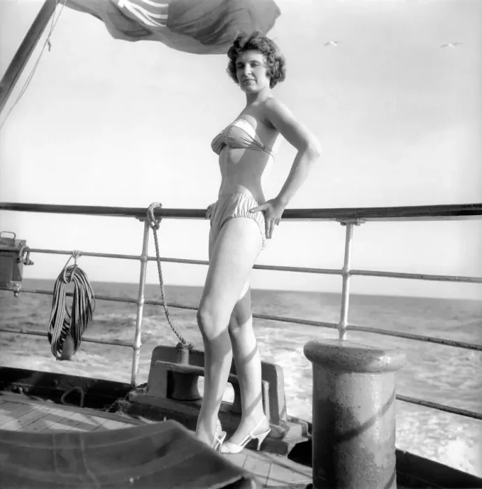 Framed Print : Julie Alexander models the latest swimwear whilst on a sail ship in the channel Framed Print : Julie Alexander models the latest swimwear whilst on a sail ship in the channel