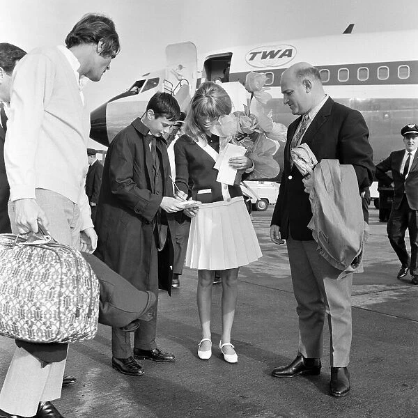 Julie Christie and boyfriend Don Bessant arriving at London Airport after she was awarded
