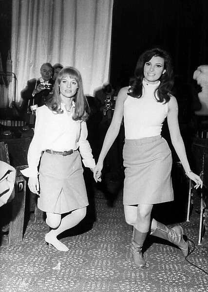 Julie Christie and Raquel Welch practice curtsying 1966