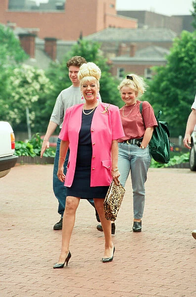 Julie Goodyear is pictured outside the set of Coronation Street greeting fans