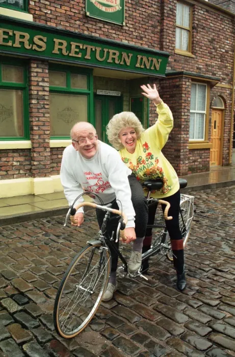 Framed Print : Julie Goodyear and Roy Barraclough pictured on a tandem bike on the set of Coronation