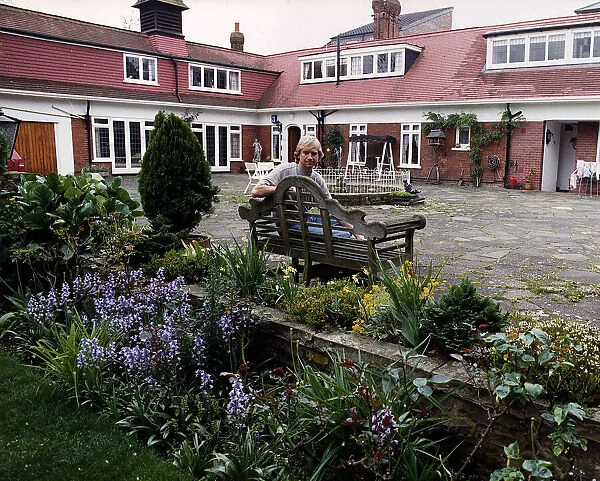 Justin Hayward, lead singer of Moody Blues, relaxes in garden. September 1988
