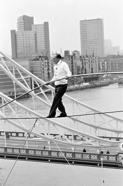 Karl Wallenda, Tightrope Walker, crosses 100ft above the ground, near Tower Bridge