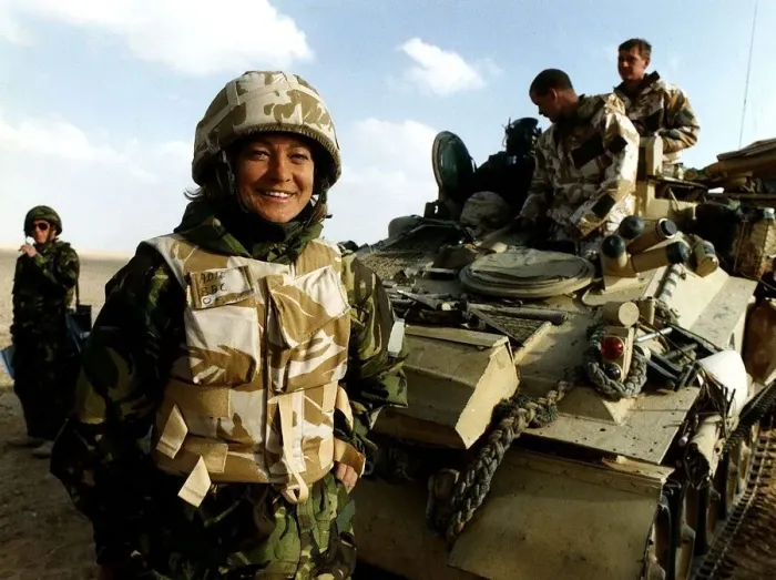 Framed Print : Kate Adie the foreign correspondent for the BBC stands in fatigues alongside soldiers Framed Print : Kate Adie the foreign correspondent for the BBC stands in fatigues alongside soldiers