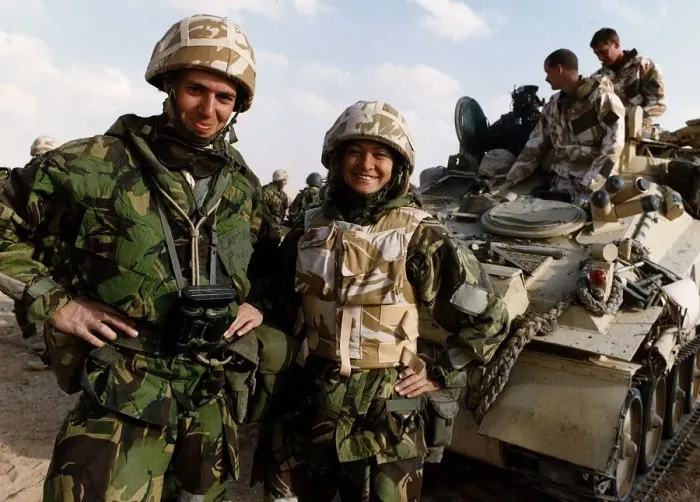 Framed Print : Kate Adie the foreign correspondent for the BBC stands in fatigues alongside soldiers Framed Print : Kate Adie the foreign correspondent for the BBC stands in fatigues alongside soldiers