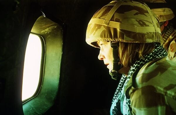Kate Adie tv reporter looking out of a helicopter window on her way to join the army unit