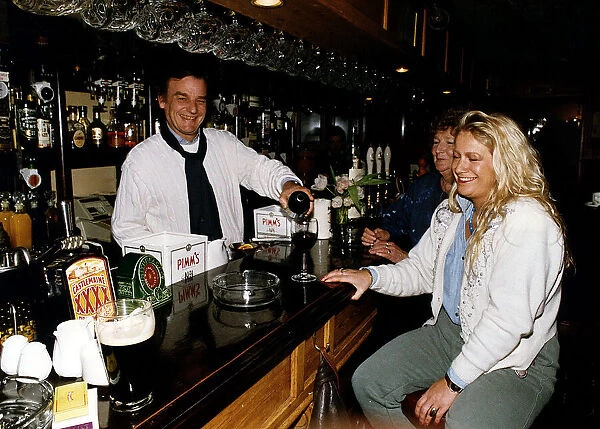 Keith Floyd Television Chef serving drinks from behind the bar at The Maltsters Arms near