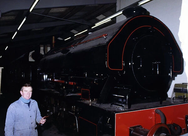 Keith McNulty, Hon. Treasurer with a Bagnall 0-6-0 locomotive built in 1950 at the George