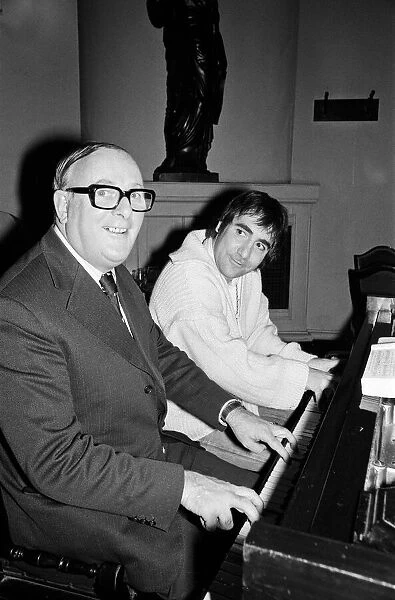 Keith Moon, drummer with British rock group The Who, pictured at the piano with