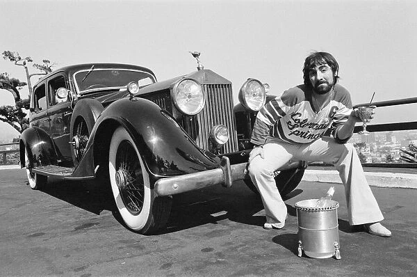 Keith Moon, drummer of The Who rock group, with his 1929 built Rolls Royce car in