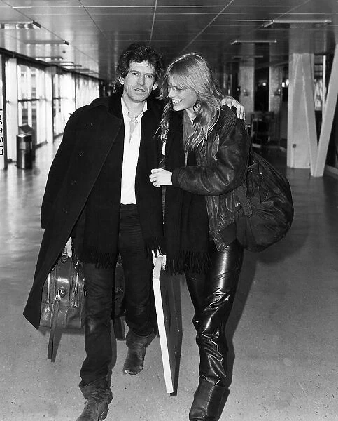 Keith Richards guitarist with the Rolling Stones leaving Heathrow with his girlfriend