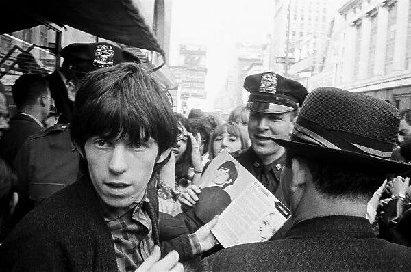 Keith Richards of The Rolling Stones signing autographs on Broadway. 2nd June 1964