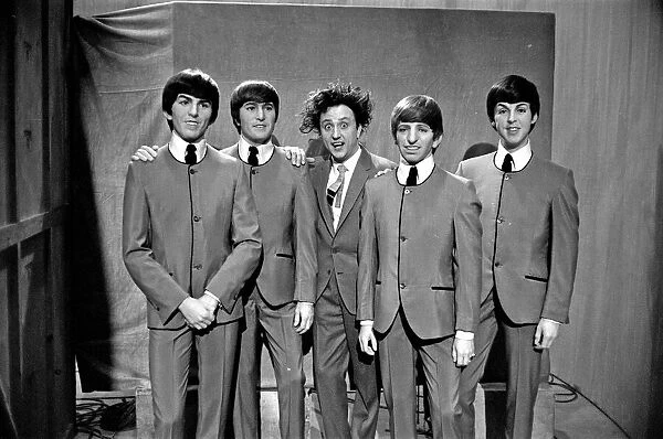 Ken Dodd (centre) posing with Madame Tussauds figures of The Beatles