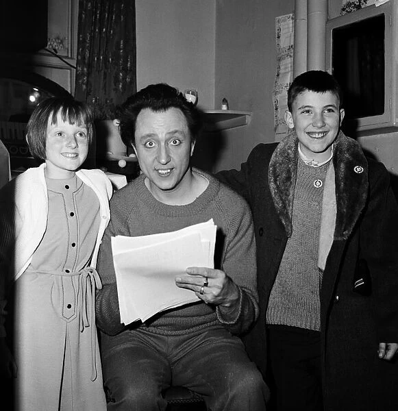 Ken Dodd in his dressing room at the Palladium with children. 13th December 1965