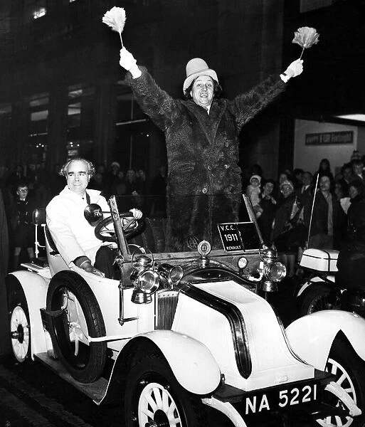 Ken Dodd driving through Liverpool in a 1911 Renault, to turn on the Christmas lights