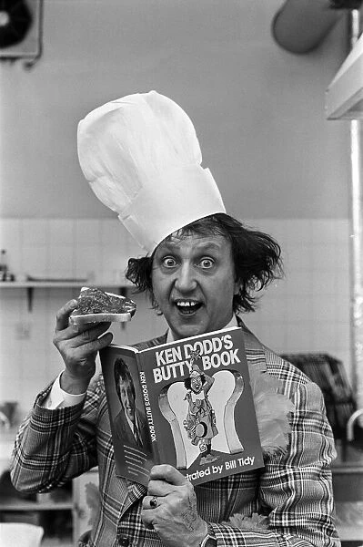 Ken Dodd with a jam butty and the butty book. 15th October 1977