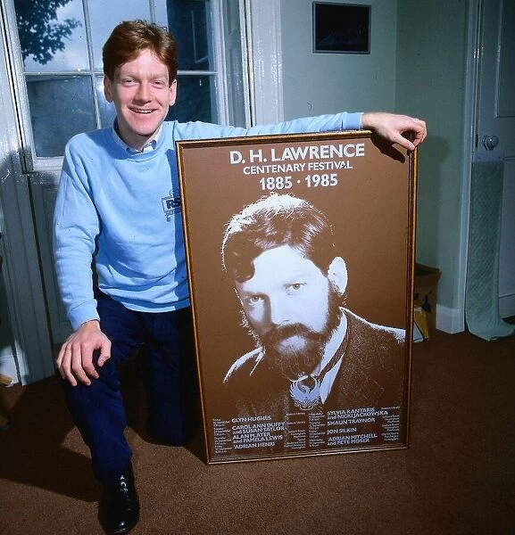 Kenneth Branagh actor director 1985 with large poster of D H Lawrence centenary