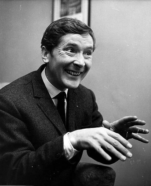 Kenneth Williams comedian hands held out in front in agents office Cork St December