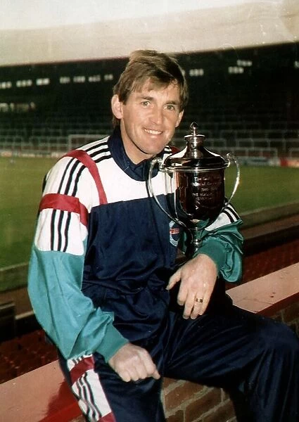 Kenny Dalglish former Footballer and Football Manager holding Man of the Decade trophy