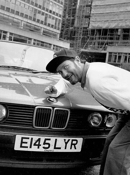Kenny Everett sitting with his new BMW car 21  /  07  /  1989