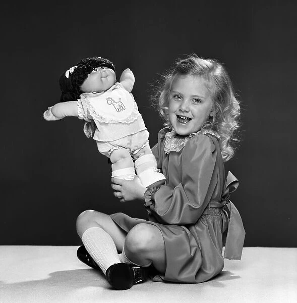 Keri Reynolds, aged 5, with her Cabbage Patch doll. 2nd December 1983