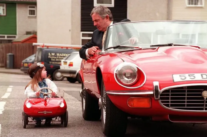 Framed Print : Kerri Duncan in Toy E type Jaguar car April 1998, parked alongside Graeme Moyes principal