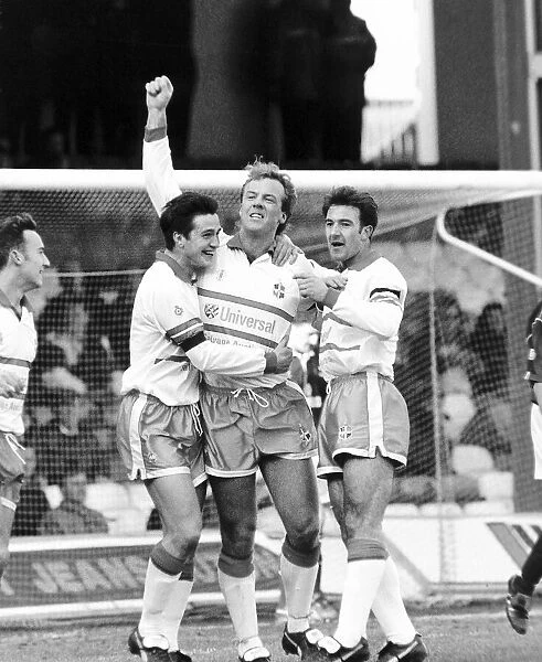 Kerry Dixon, football player for Luton, with arm in air after scoring a goal