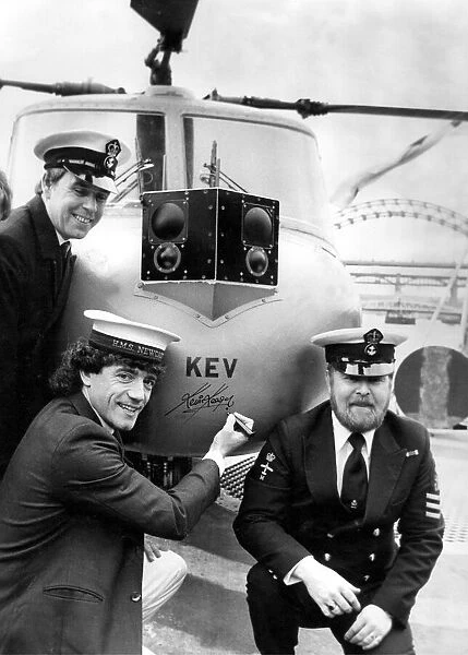 Kevin Keegan autographs the helicopter which is named after him on HMS Newcastle