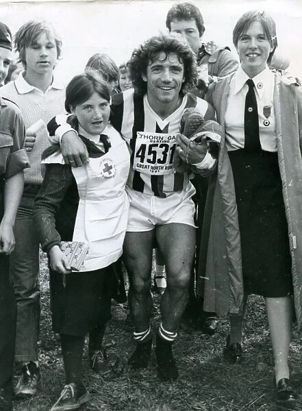 Kevin Keegan being helped by Red Cross girls in the Great North Run 1981