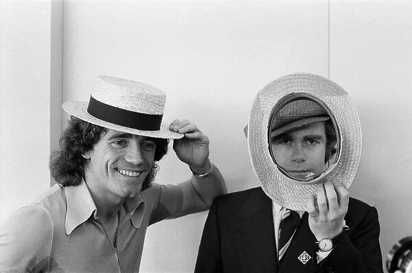 Kevin Keegan in a straw boater hat and Elton John in his own hat