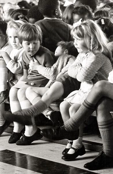 Kids getting bored of sitting around. Circa 1970