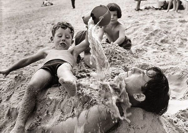 Kids playing on the beach, circa 1950