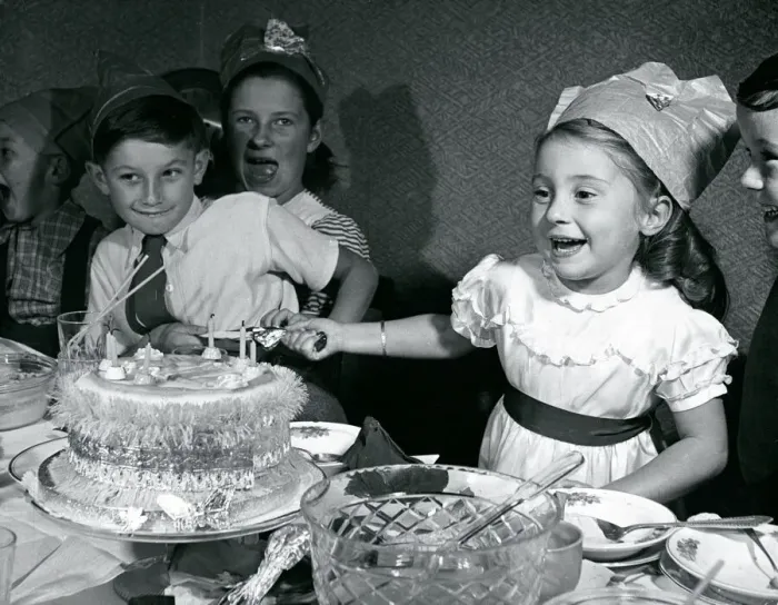 Framed Print : Kids pull crackers at Christmas party 1950 Infront of xmas cake